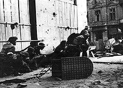 Home Army soldiers assault a fortified house in downtown Warsaw during the Warsaw Uprising of 1944