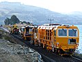 Plasser & Theurer DGS 62 N dynamic track stabilizer, followed by SSP 300 Regulator, then a Plasser 09-16 CAT Continuous Action Tamper, in Blueskin Bay, New Zealand.