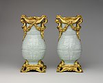 Pair of Chinese vases with French Rococo mounts; the vases: early 18th century, the mounts: 1760–70; hard-paste porcelain with gilt-bronze mounts; 32.4 × 16.5 × 12.4 cm; Metropolitan Museum of Art