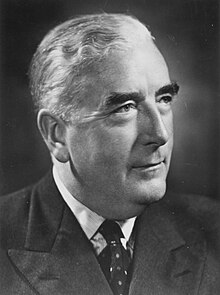 Menzies was thickset elderly Anglo-Saxon man, cleanshaven and wearing a suit.