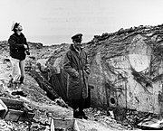 CY Cook (left) and LCDR Knapper of USS Texas (BB-35) inspecting bombardment damage, Pointe du Hoc, France, 1944.