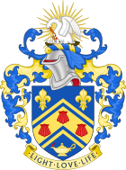 Arms of Southlands College. Shield: Azure, on a chevron cotised between in chief two fleurs-de-lys and in base a lamp Or inflamed proper, three escallops gules; crest: On a wreath of the colours, In front of a demi sun Or a pelican in her piety proper; motto: Light, love, life.