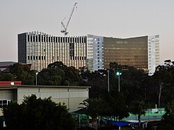 A photograph of two neighbouring buildings, each belonging to the University of South Australia and the University of Adelaide respectively.