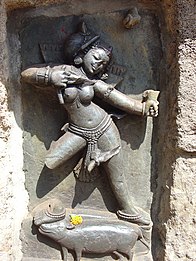 One of the Yoginis of Chausathi Yogini Temple at Hirapur, Odisha. There is an offering of flowers at the yogini's feet.