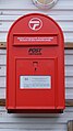 A red postbox of Post Greenland by the entrance