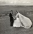 John F. Kennedy and Jacqueline Bouvier Kennedy, in morning dress and wedding gown, outdoors (1953)