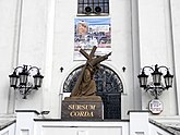A sculpture depicting Saint Francis carrying a cross.