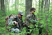 Soldiers with 2nd Battalion, 19th Special Forces Group check their course with compasses during a foot patrol while training at Camp Atterbury Joint Maneuver Training Center, Indiana