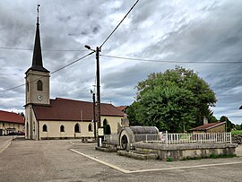 The fountain and church in Le Luhier