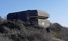 A photograph of a concrete military fortification element