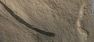 Dark slope streaks along a mesa wall, as seen by HIRISE. Picture is about 1 km across.