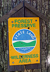 A Department of Conservation sign marking State-land boundary.