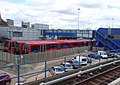 Two B07/09 rolling stock next to an older B92 rolling stock at the Poplar DLR depot next to Poplar DLR Station.