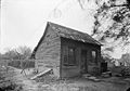 A 1936 photo of the Lasource–Durand Cabin behind the Amoureux House