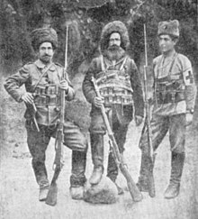 Photograph of three brothers posing with their rifles – volunteers in the Russian army