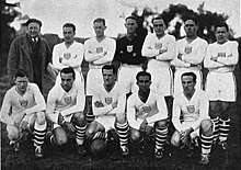 Another team photo; some members are kneeling, and others are standing.