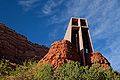 A picture of the Chapel of the Holy Cross in Sedona, Arizona near sunset. The chapel appears to rise out of the rock formations characteristic of the area.