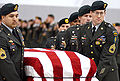 A casket team from the 1st Special Forces Group carries the flag-draped casket of Sergeant First Class Nathan Chapman on January 8, 2002.