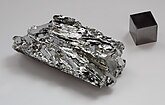 Molybdenum crystals and a 1 cm3 molybdenum cube for comparison