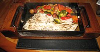 "Fish in a box", fresh fish served with Mediterranean vegetables in a Montevideo, Uruguay restaurant