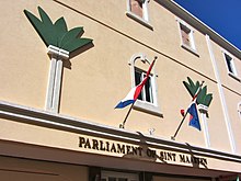 Image of the Parliament of Sint Maarten building displaying the flag of Sint Maarten and the Netherlands