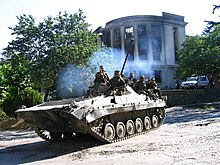 Tank-like vehicle with soldiers aboard