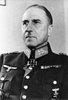 A man wearing a military uniform, various military decorations including an Iron Cross displayed at the front of his uniform collar.