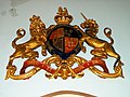 The Royal Coat of Arms given by King George V to replace an earlier set which were lost in a fire. These arms hang above the west door.