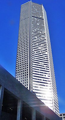 Tall, steel, five-sided tower, with strong vertical lines broken by rows of horizontal bands on two sides.