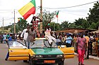 Beninese men waving the national flag on independence day (2016)