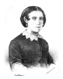 B&W portrait image of a seated woman, short hair parted down the middle, wearing earrings and a dark shirt with a white lace collar.