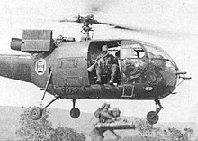 Armed soldier in a helicopter