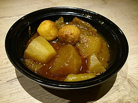 A bowl of curry fish balls, pork rinds and radish sold in Hong Kong