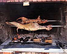 Spit-roasting a lamb and a suckling pig