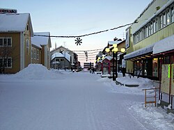 The main street (Storgatan) with snow and Christmas lights in Gällivare at about noon in December 2005.