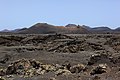 Vulkankegel Montaña de las Lapas auf Lanzarote, umflossen von erstarrter, aschebedeckter Lava