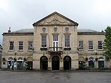 Symmetrical two-storey building in classical style with nine bays.