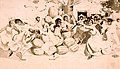 Lithograph of Black people dancing around a pile of watermelons, circa 1900