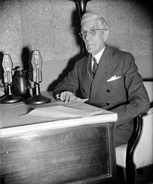 Francis Townsend, seated at desk, with microphones, c. 1939