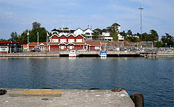 Grisslehamns harbour, with the ferry terminal (the red building) and Hotell Havsbaden (the white building behind).