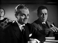 Bogart behind a smiling James Cagney in a film trailer