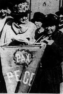 Photograph of two women holding a peace banner