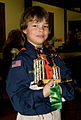 Image 13A happy Cub Scout holds a winning pine car
