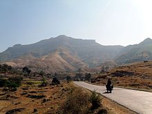 A road, with mountains in the background