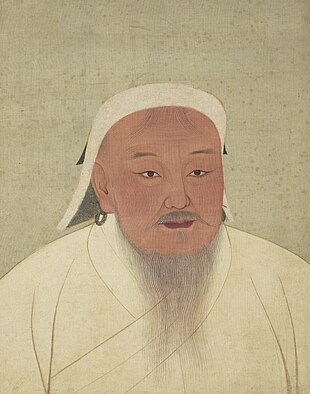 An old bearded man in white robes and cap.