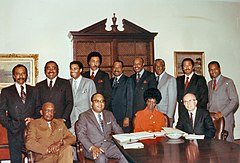 Rangel and twelve other African American members of Congress posed around a table