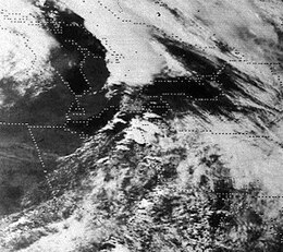 Black-and-white aerial photograph outlining state boundaries and highlighting thunderstorm anvils