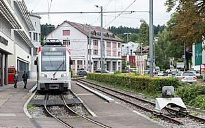 Silver vehicle on track next to the station