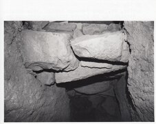 Inside the passage, looking up, seeing entrance stones and upper tunnel