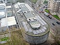 A bird's eye photo shows the length of Swiss Cottage library, a long, pill like structure